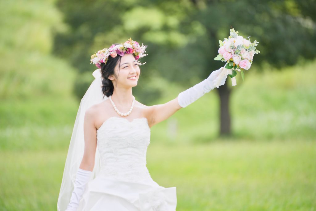 花冠をつけてブーケを掲げる花嫁